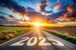 © Tekin - New year 2025 or straightforward concept. Text 2025 written on the road in the middle of asphalt road at sunset.Concept of planning and challenge, business strategy, opportunity ,hope, new life change