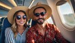 © gankevstock - A happy couple sitting in an airplane cabin, both wearing straw hats and sunglasses, enjoying their flight