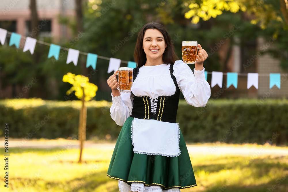 Young Octoberfest waitress with beer outdoors