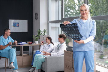 Sticker - Female doctor studying x-ray image in clinic