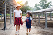 © chaunpis - Two young girls on the farm, outdoors. A large solar panel in the field behind them.