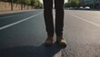 © Александр Бердюгин - A man in stylish shoes stands confidently on an empty city street, conveying a sense of urban style and individuality