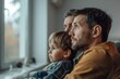 © Dina - Father's Day, two dads spending time with their son, sitting on couch or sofa, watching football or soccer or other sports game on tv, father raising his boy, smiling happily