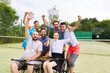 © Robert Kneschke - Inclusive group of friends celebrates a win on tennis court with person in wheelchair