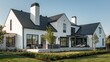 © Rasheed - modern suburban farmhouse with a monochrome exterior, featuring a black slate roof and white stucco walls