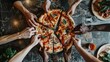© Summit Art Creations - Diverse people hands reaching for a mixed topping pizza on a flour-dusted table. Top down aerial view of people with mixed raced holding and sharing the pizza pieces. Food and sharing concept. AIG53F.