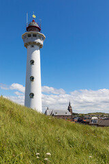 Wall Mural - Lighthouse and church at Egmond Aan Zee, The netherlands