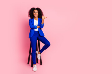 Poster - Photo of adorable lovely girl wear trendy blue clothes sit wooden stool empty space isolated on pink color background