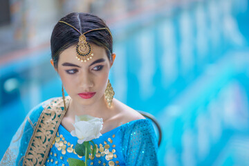 Beautiful fashionable Indian woman wearing Hindu Bride in a saree dress a traditional costume.