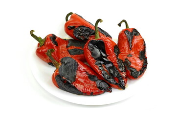 Wall Mural - Fire roasted sweet red pepper photographed on a white background. Grilled red bell peppers prepared for making salad. Delicious Roasted Red Pepper Isolated