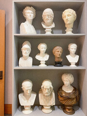 a bunch of busts on shelves