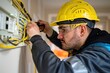 © zenith - A man in a yellow helmet is working on electrical wires