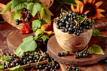 Ripe black currant on a brown table.