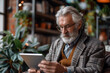© Bojan - Tech-Savvy Senior, Mature Man Engaged with Digital Tablet