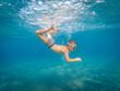 © Zoran Zeremski - Boy with a mask is diving underwater at sea.