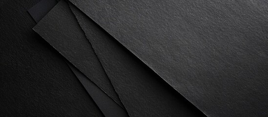 Fototapete - Background with a textured black paper giving space for an image. image with copy space