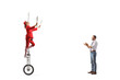 © Ljupco Smokovski - Man giving an applause and watching an acrobat riding a giraffe unicycle and juggling