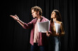 © LIGHTFIELD STUDIOS - A man and woman rehearse together, holding papers.