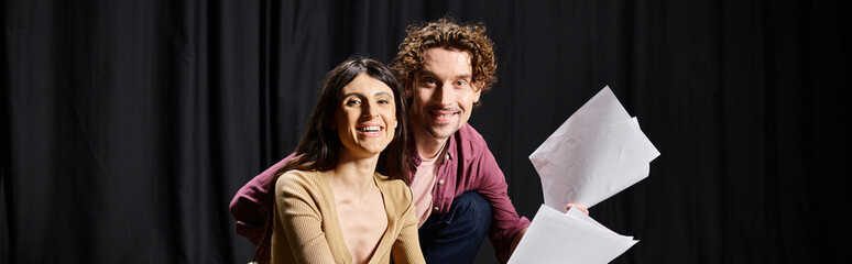 Wall Mural - A stylish man and woman strike a pose during theater rehearsals.