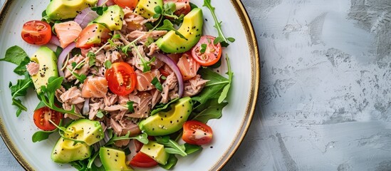 Wall Mural - Top view of a plate with avocado tuna salad, showcasing organic and healthy ingredients. Ideal for illustrating detox and clean diet concepts with copy space image.