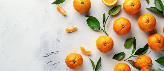 Wall Mural - Top view of ripe fresh tangerines on a light background with copy space image, showcasing a food concept in a flat layout.