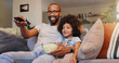 © peopleimages.com - Dad, boy and happy with television or popcorn on sofa in living room for movies, cartoon and entertainment. People, parent and smile with kid on couch for streaming platform with child development