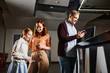 © LIGHTFIELD STUDIOS - people joyfully engaged with a cell phone, bonding as a happy family in a cozy setting.