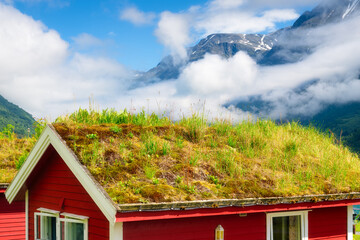 Poster - Traditional Scandinavian houses with moss on the roof. Beautiful mountain lake in Norway. Nature in the fjords. Vacation and travel in summer Norway.