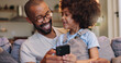 © WesSide/peopleimages.com - Phone, dad or boy in home for playing or streaming online together for movie, website or technology. Happy family, download or single parent father with child, kid or mobile for learning development