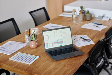 Wall Mural - High angle shot of workplace equipped with digital devices and brochures with analytical diagrams and decor items