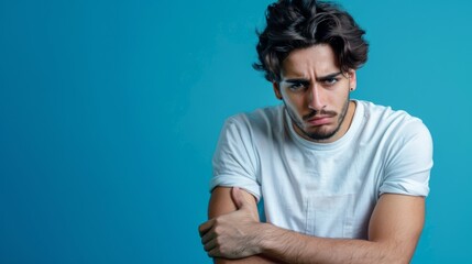 Wall Mural - Portrait of an unhappy young man , blue color background, with copy space