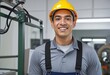 © SR07XC3 - Portrait of a confident Hispanic factory manager in a workshop setting, wearing a hard hat and smiling at the camera