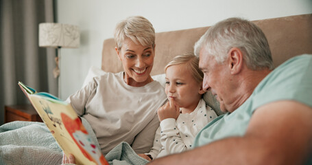 Wall Mural - Grandparents, girl and reading book in bed for fairytale, literature and bonding at sleepover. Home, grandchild and people learning together for love, language and grandma or grandpa for bedtime