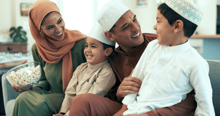 Sticker - Muslim family, popcorn and watching tv on sofa in living room of home for bonding or comedy. Laughing, television or video with Islamic mother, father and kids in apartment for movie streaming