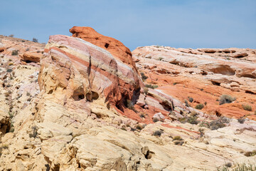 A rocky hillside with a large rock in the middle