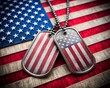 © Tekin - US military dog tags in the shape of the American flag. Memorial Day for Veterans Day concept.