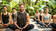 © chris3d - A group of men and women engage in a tranquil morning yoga session on wooden platforms surrounded by lush tropical forest. The instructor is smiling at the camera - Generative AI