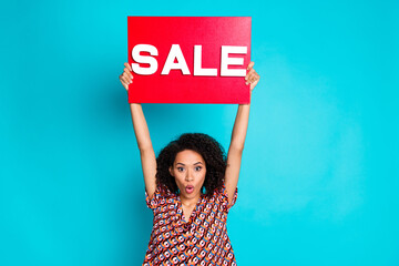 Wall Mural - Photo of attractive girl feel shocked show paper sale placard isolated cyan color background