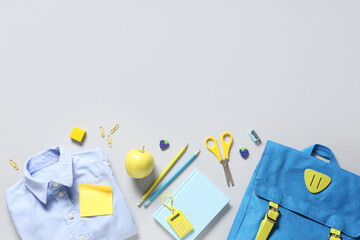 Wall Mural - Shirt, tasty apple, backpack and different school stationery on white background