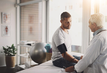 Canvas Print - Exam, man and doctor in clinic for blood pressure, checkup and healthcare assessment test. Advice, patient and medical professional in office for hypertension, heart or health insurance consultation