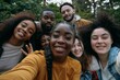 © senyumanmu - diverse friends chilling outside taking group selfie and smiling