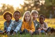 © senyumanmu - Group of cute diverse kids sitting together in park and looking at camera