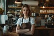 © senyumanmu - confident female barista standing behind counter looking at camera
