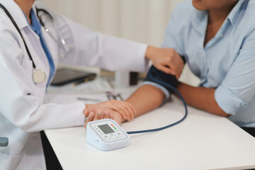 The doctor woman hand use the pulse meter to measure the pressure of the patient, medical checkup concept.