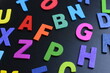 © sutichak - colorful letter alphabet on black background, object for education