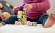 © CineLens2024/peopleimages.com - Baby, playing and building blocks in game for growth, development and curiosity with motor skills. Toddler, toys and alphabet puzzle in education, learning and fun for cognitive ability in home