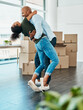 © peopleimages.com - Couple, happy and hug in new home with boxes, connection and excited for fresh start with property. African man, woman and moving with package in apartment, real estate and investment with mortgage