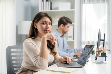 Wall Mural - Smiling beautiful woman working on laptop aligning taking note to pose for looking at camera photo shooting portrait profile's business with smart coworker at modern office at morning time. Postulate.