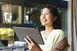 © Wavebreak Media - Happy asian woman with short hair using tablet at home