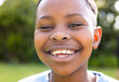 © Wavebreak Media - African American boy smiles brightly outdoors, unaltered